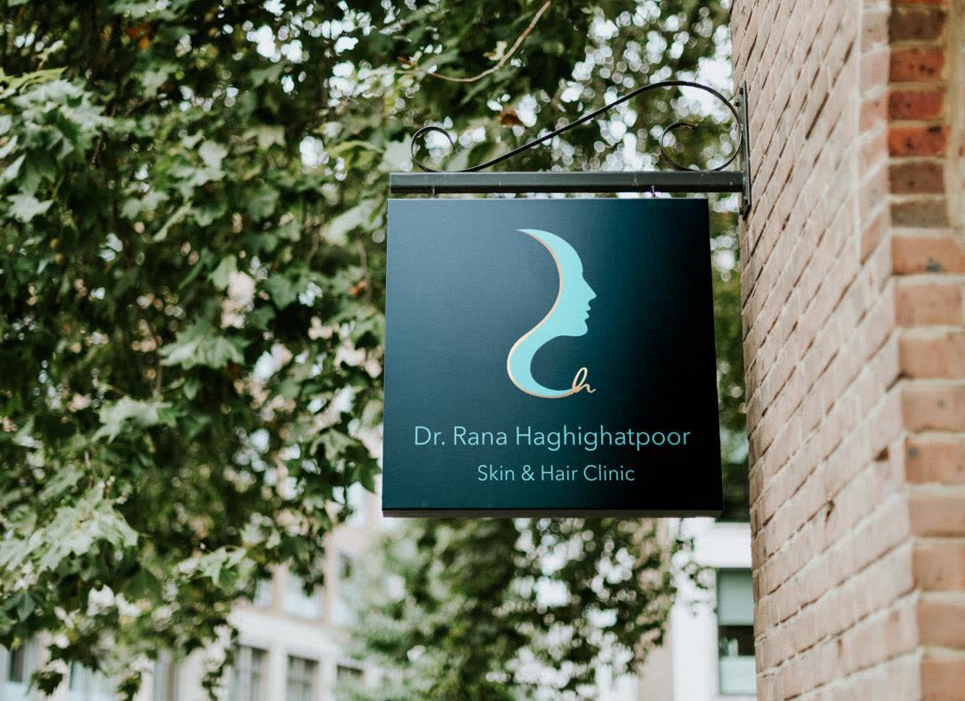 Hanging outdoor sign for Dr. Rana Haghighatpoor Skin & Hair Clinic.